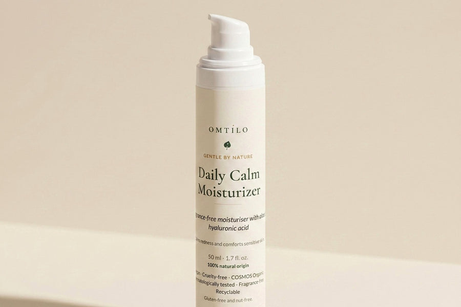 The OMTILO Daily Calm Moisturizer standing quietly on a warm beige surface