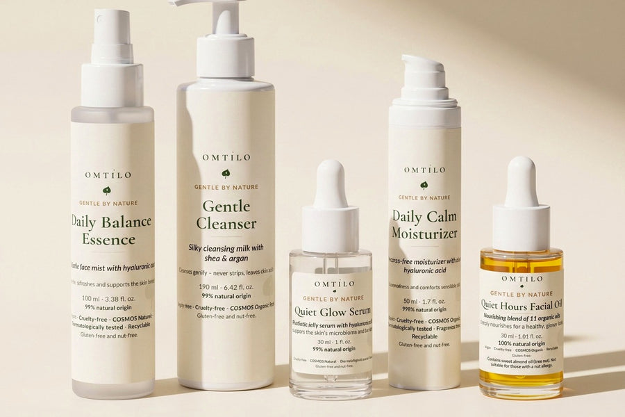 The full OMTILO skincare range lined up on a warm beige surface