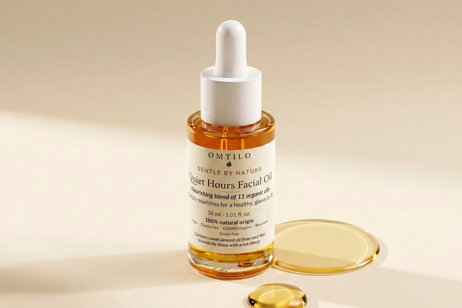 The OMTILO Quiet Hours Facial Oil with golden oil droplets