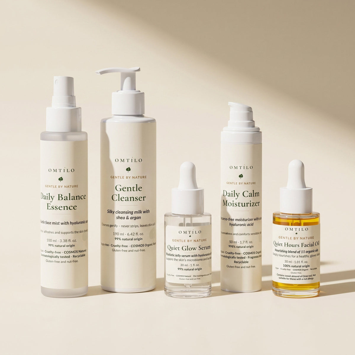 The five OMTILO products in a row on a soft cream surface in daylight